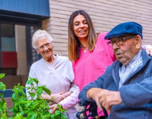 Nurse and seniors in a vegetable garden in a nursing home
